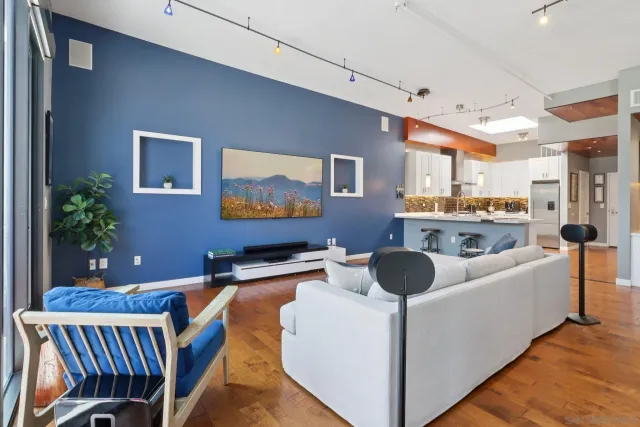 a living room with furniture and a potted plant