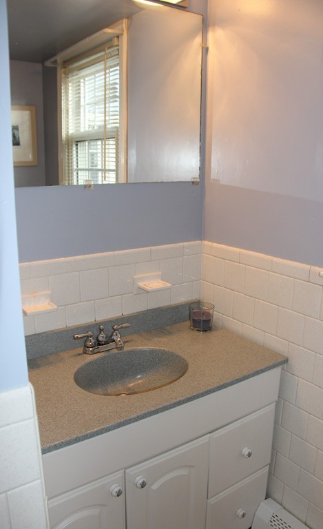 21 Casey Street Canton, MA 02021 - Photo 21 of 29 a bathroom with a sink and a mirror