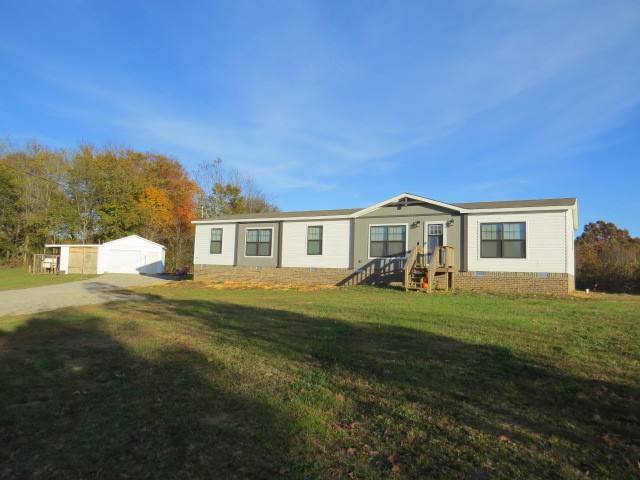 273 Miller Lane Goodspring, TN 38460 - Photo 1 of 42 a front view of a house with a garden