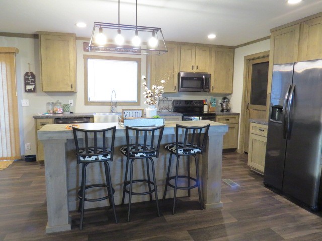 273 Miller Lane Goodspring, TN 38460 - Photo 9 of 42 a kitchen with stainless steel appliances a dining table chairs stove refrigerator and microwave