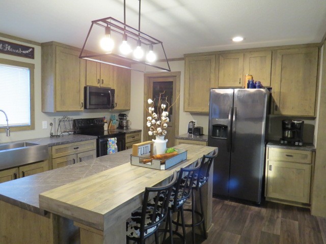 273 Miller Lane Goodspring, TN 38460 - Photo 10 of 42 a kitchen with stainless steel appliances granite countertop a refrigerator a stove a sink a dining table and chairs