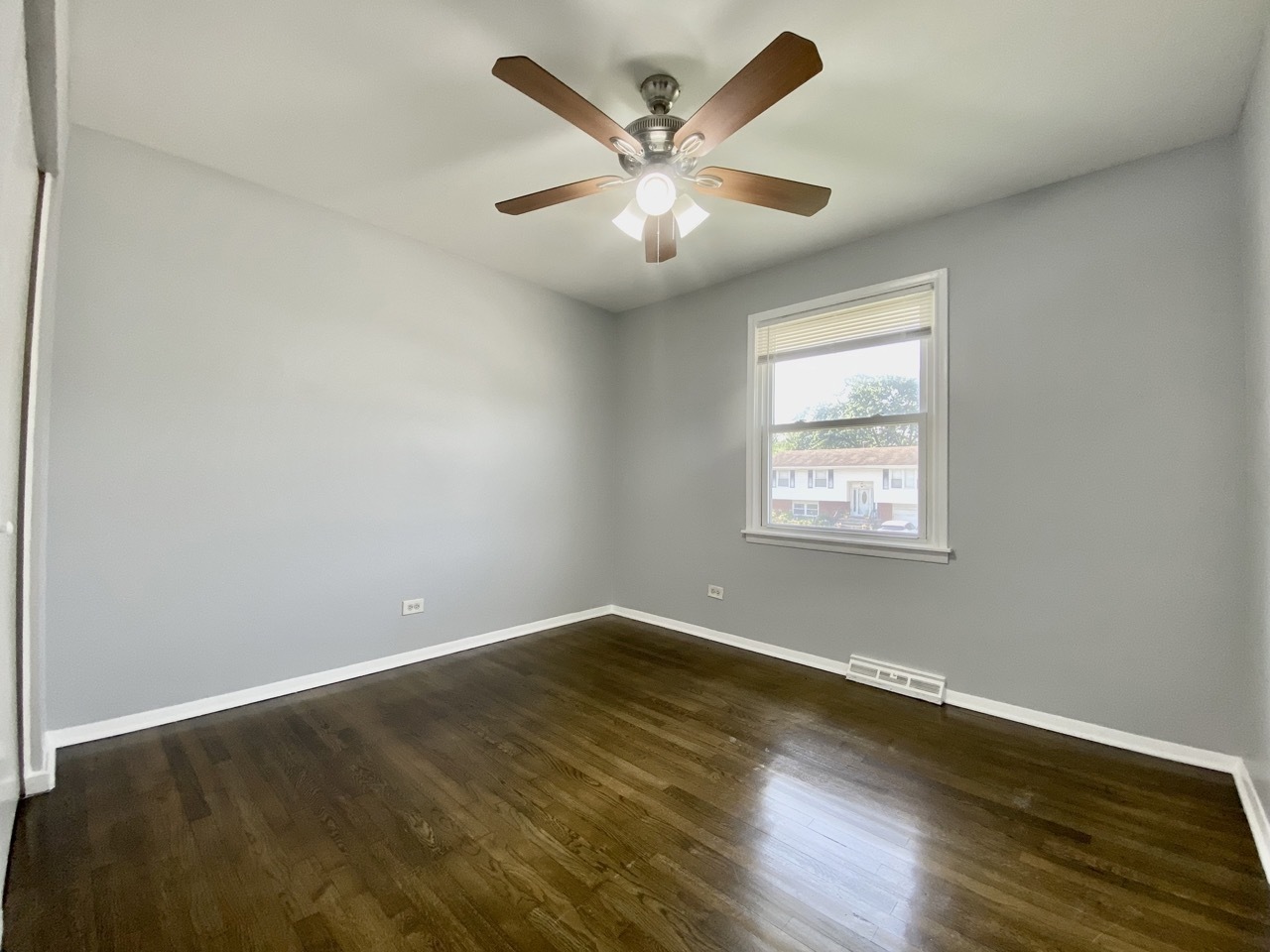 3324 Laurel Lane Hazel Crest, IL 60429 - Photo 16 of 26 an empty room with wooden floor and ceiling fan