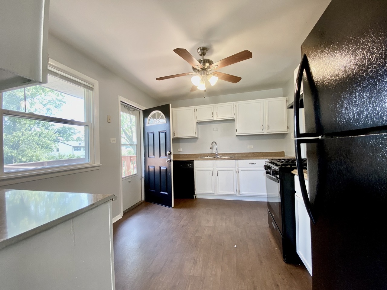 3324 Laurel Lane Hazel Crest, IL 60429 - Photo 8 of 26 a kitchen with stainless steel appliances a refrigerator a sink a stove a microwave oven a sink with wooden floor and cabinets
