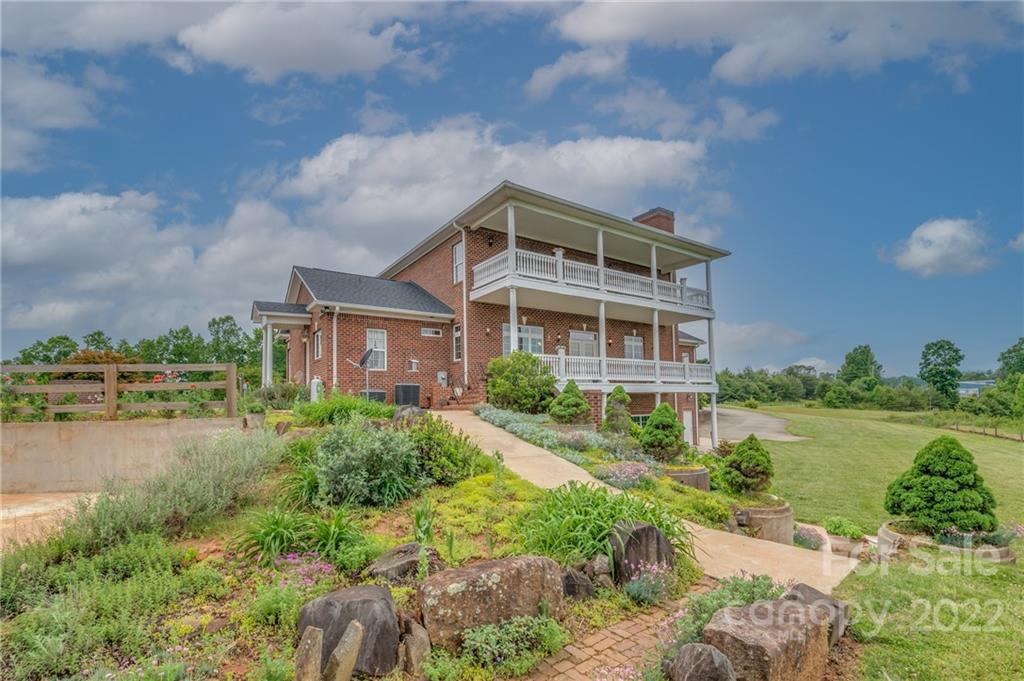2221 Pea Ridge Road Mill Spring, NC 28756 - Photo 5 of 48 a front view of a house with a yard and lake view