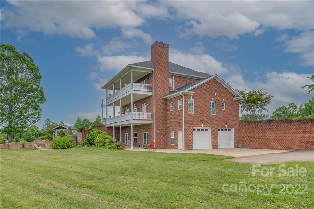 2221 Pea Ridge Road Mill Spring, NC 28756 - Photo 7 of 48 a front view of a house with a garden