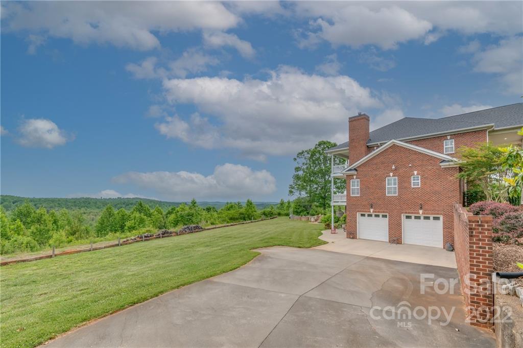 2221 Pea Ridge Road Mill Spring, NC 28756 - Photo 8 of 48 a front view of a house with a yard