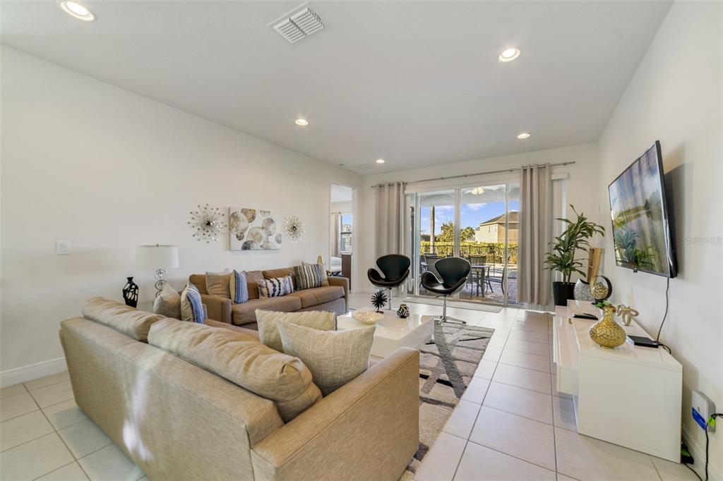 180 Minton Loop Kissimmee, FL 34747 - Photo 16 of 49 a living room with furniture and a flat screen tv