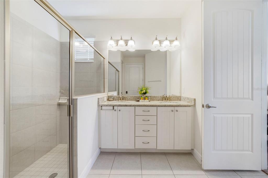 180 Minton Loop Kissimmee, FL 34747 - Photo 19 of 49 a bathroom with a sink vanity and a mirror