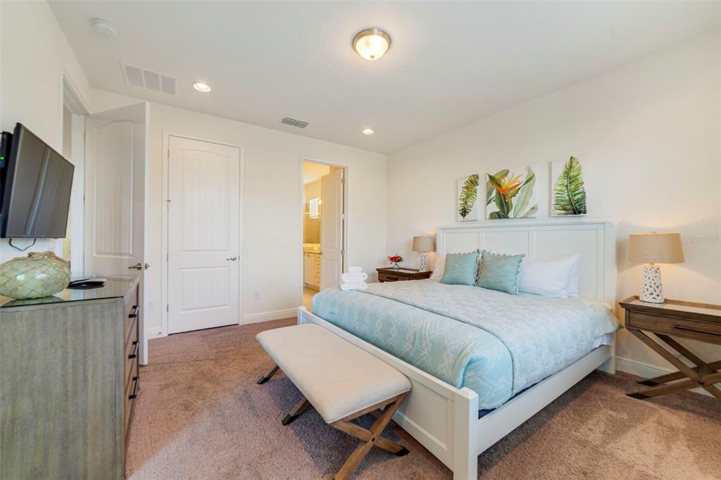 180 Minton Loop Kissimmee, FL 34747 - Photo 20 of 49 a bedroom with a bed and a flat screen tv