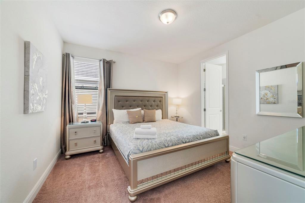 180 Minton Loop Kissimmee, FL 34747 - Photo 23 of 49 a bedroom with a bed and window