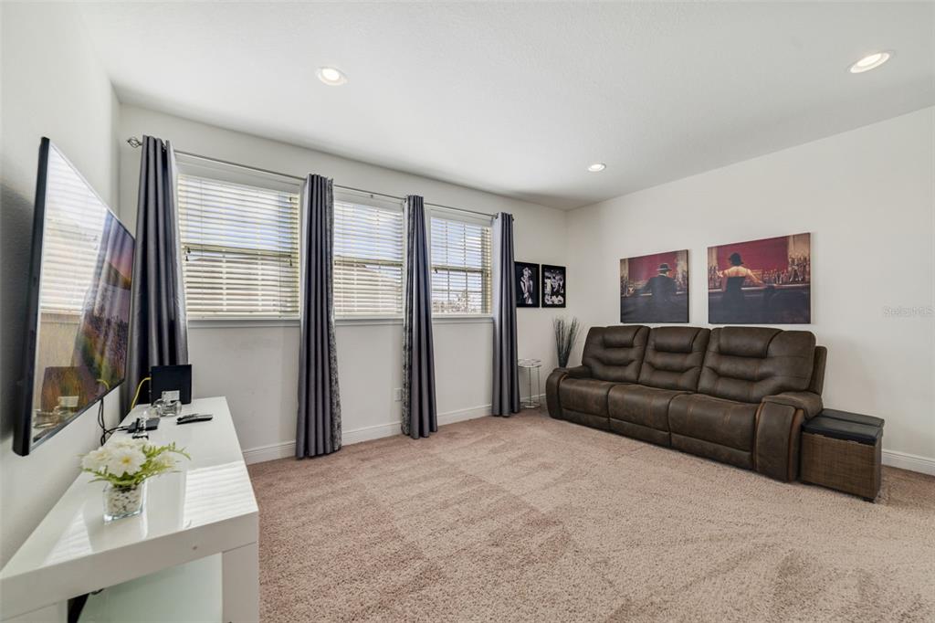 180 Minton Loop Kissimmee, FL 34747 - Photo 25 of 49 a living room with furniture flat screen tv and large window