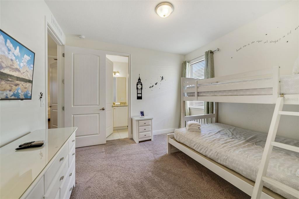 180 Minton Loop Kissimmee, FL 34747 - Photo 28 of 49 a bedroom with a bed and a refrigerator