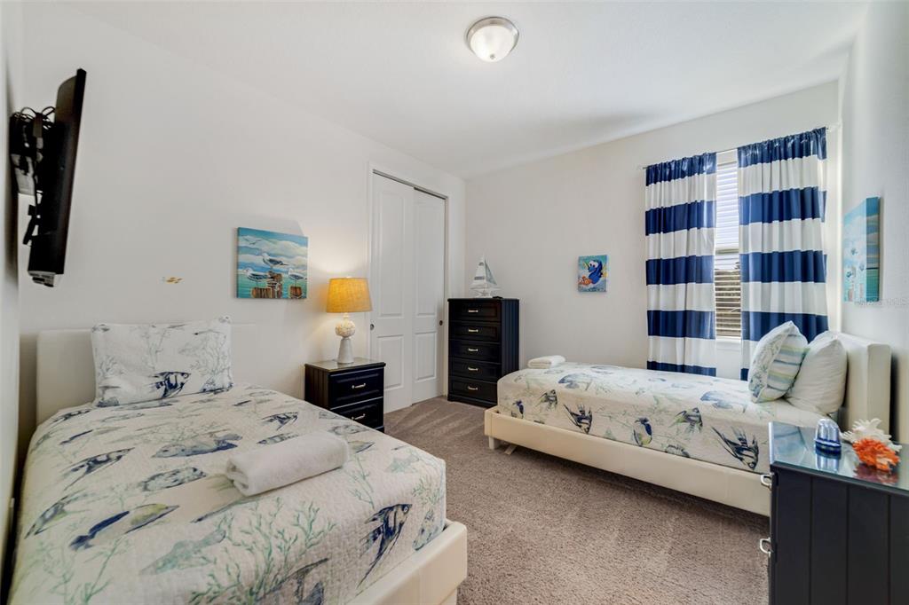 180 Minton Loop Kissimmee, FL 34747 - Photo 30 of 49 a bedroom with a bed and walk in closet