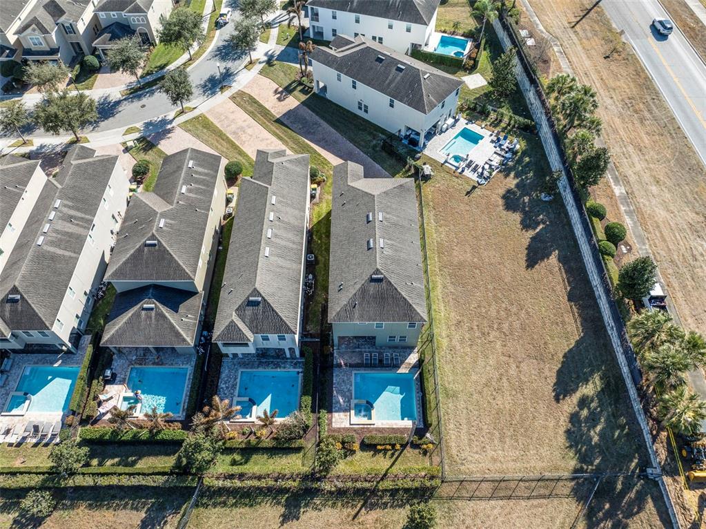 180 Minton Loop Kissimmee, FL 34747 - Photo 5 of 49 an aerial view of a house with a yard and potted plants