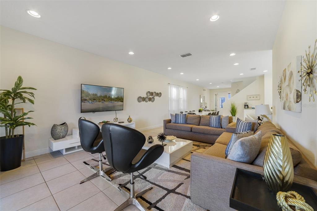 180 Minton Loop Kissimmee, FL 34747 - Photo 9 of 49 a living room with furniture and a flat screen tv