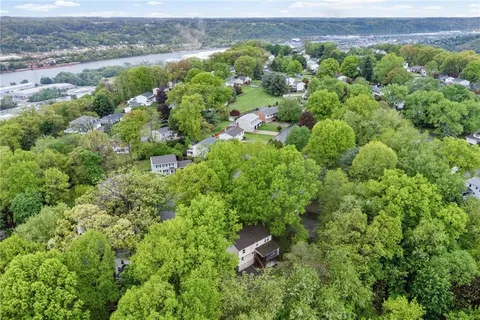 an aerial view of a house with a yard and lake view
