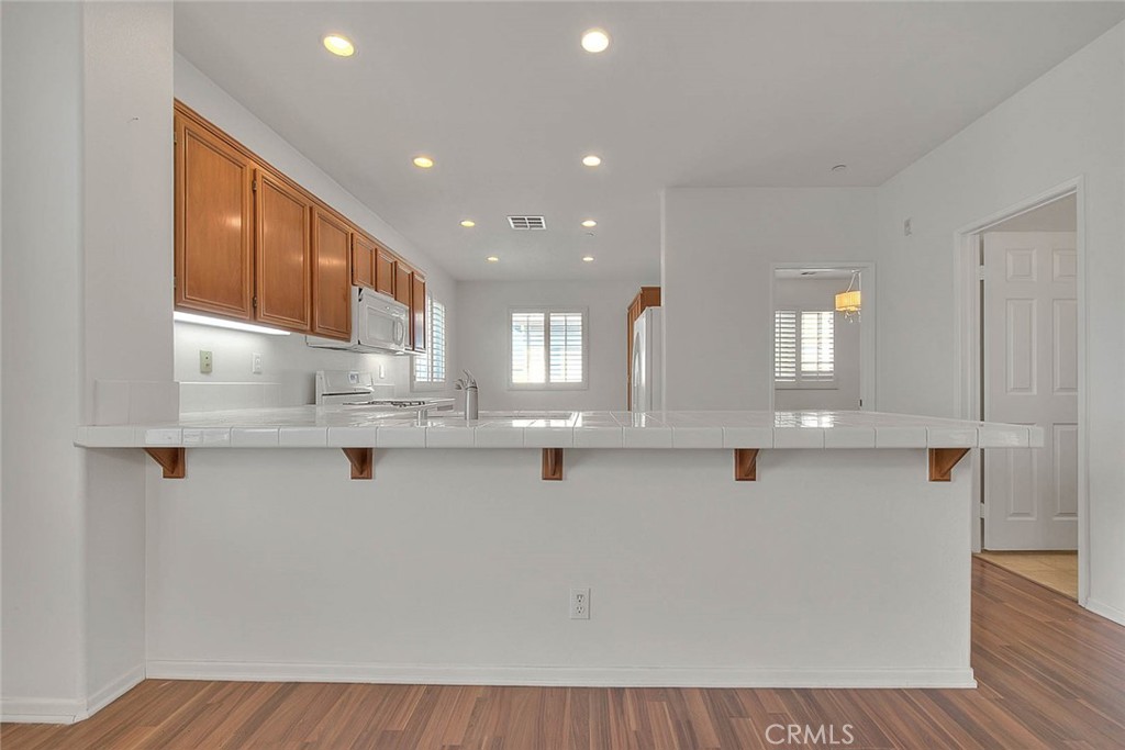 8150 West Preserve Loop Chino, CA 91708 - Photo 16 of 51 a kitchen with stainless steel appliances granite countertop a sink and cabinets