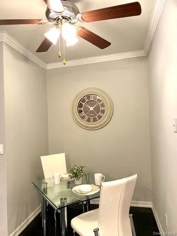a view of a dining room with furniture and a chandelier fan