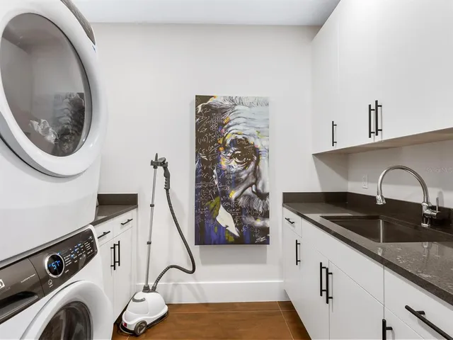 a living room with couches and a dining table with kitchen view