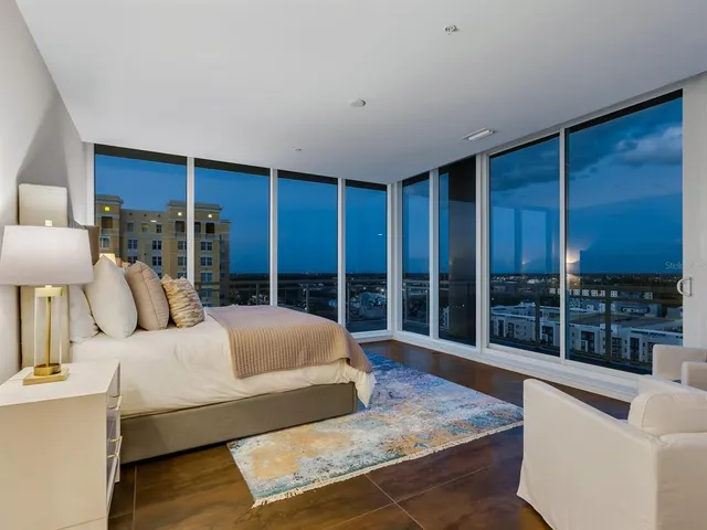 a view of swimming pool with outdoor seating and house in the background
