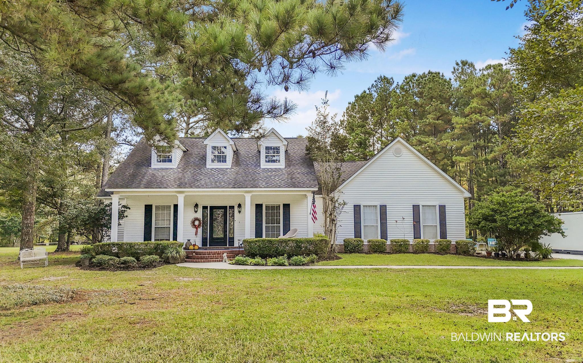 10603 Old Stage Road Stockton, AL 36579 - Photo 2 of 34 Cape cod home with a front lawn, covered porch, and a shingled roof