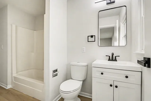 a white toilet sitting next to a bathroom sink
