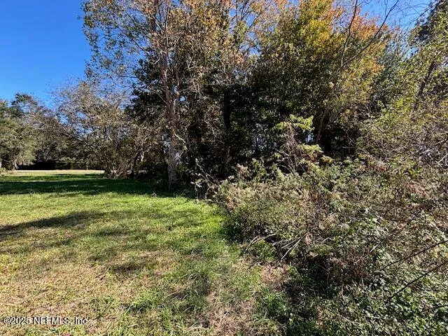 a view of outdoor space with deck and yard