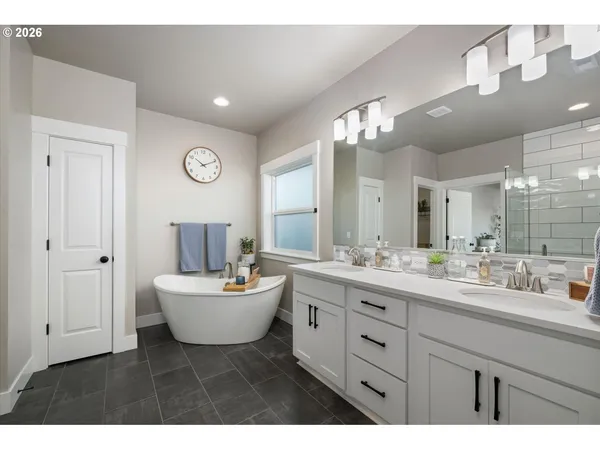a bathroom with a sink mirror and a toilet