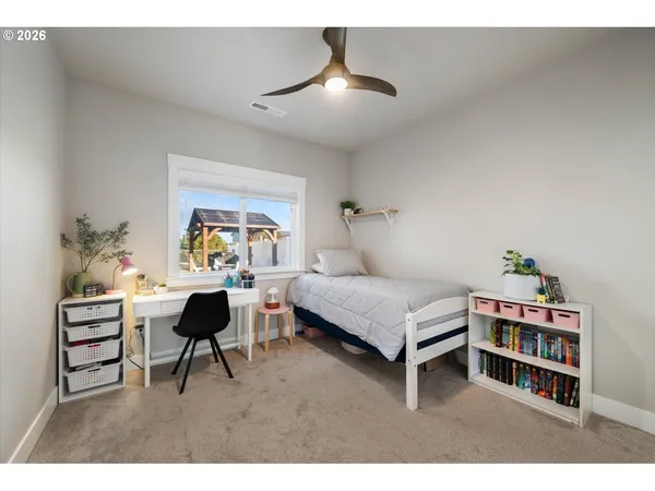 a living room with furniture and a book shelf