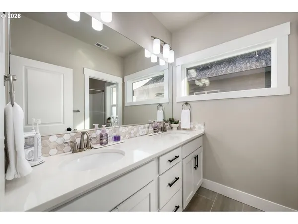 a bathroom with a sink vanity granite and a mirror