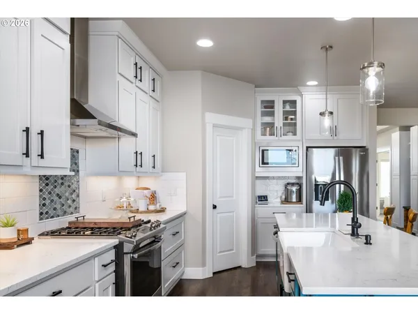 a kitchen with stainless steel appliances granite countertop a sink stove and cabinets