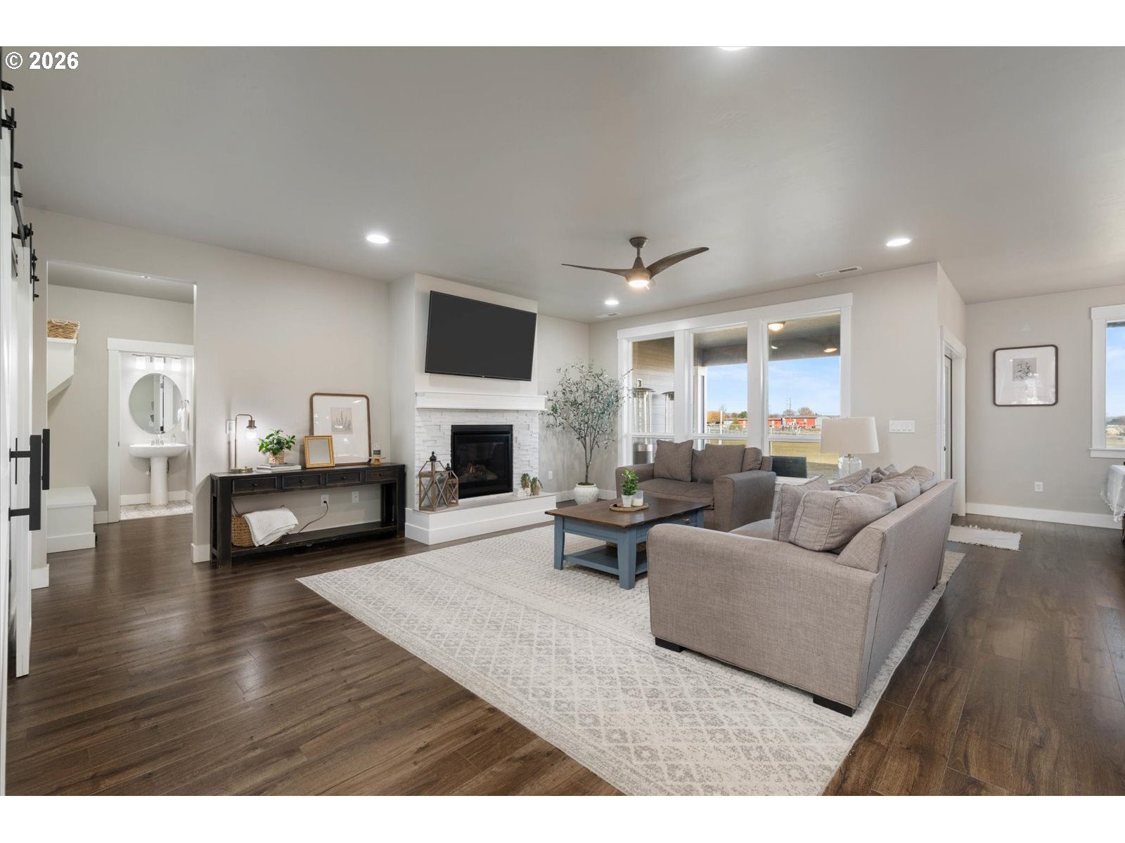 224 Rome Street Boardman, OR 97818 - Photo 4 of 23 a living room with furniture a fireplace and a flat screen tv