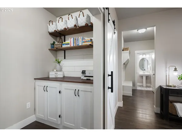 a kitchen with cabinets and wooden floor