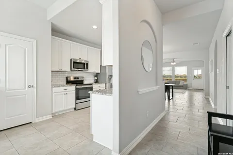 a view of kitchen with sink and refrigerator