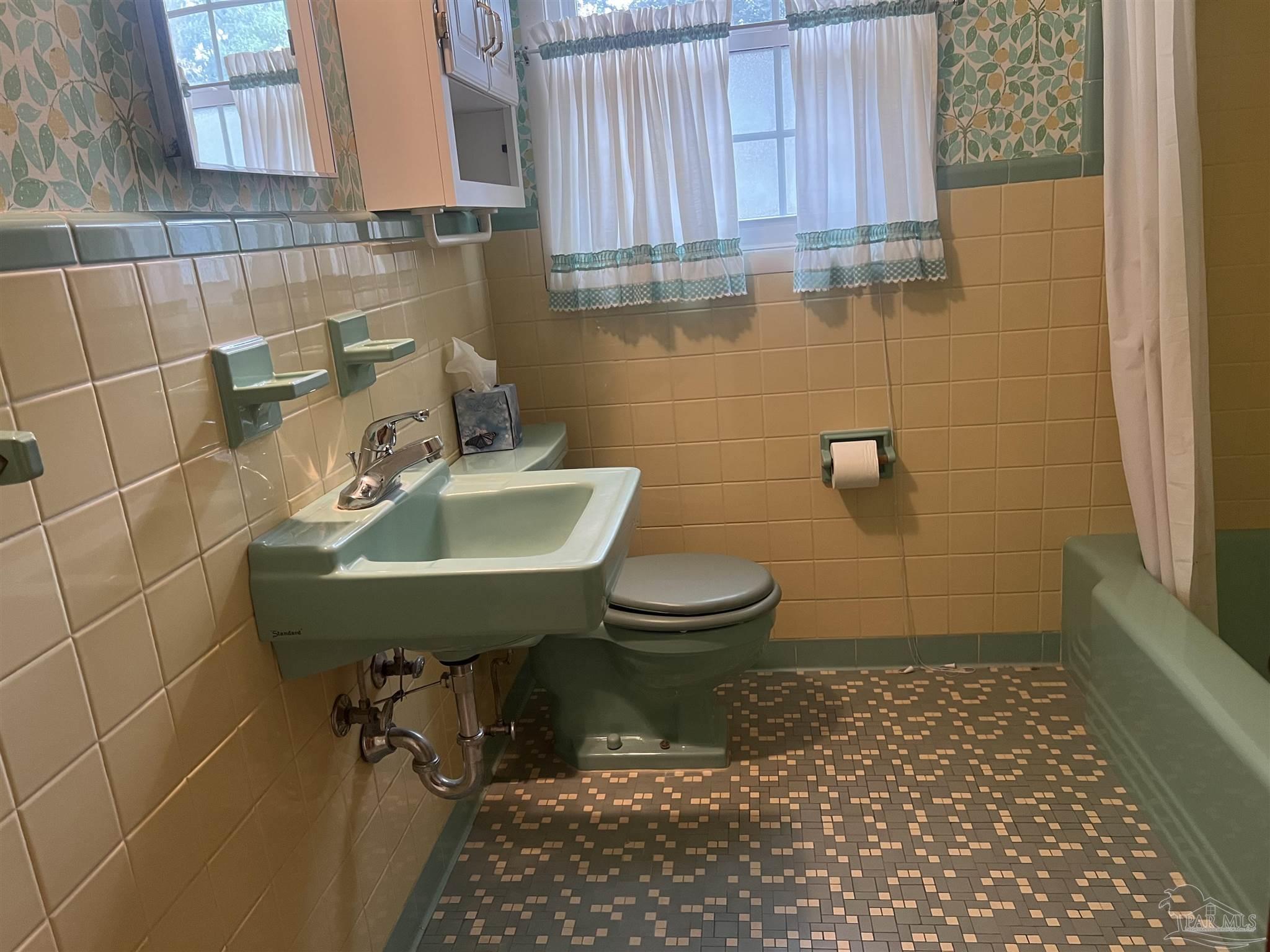 6020 Hilltop Road Pensacola, FL 32504 - Photo 11 of 27 a bathroom with a sink a toilet and mirror