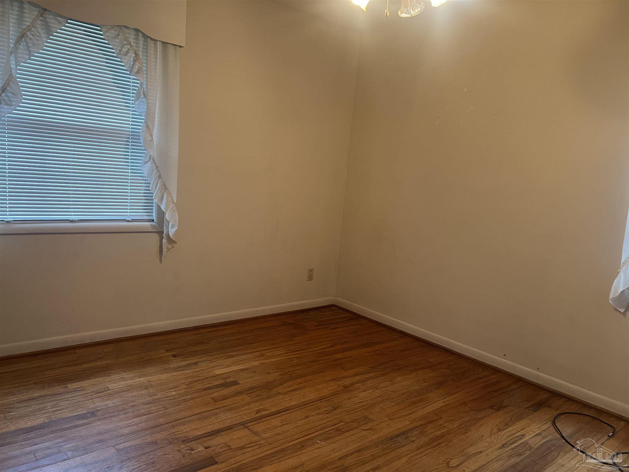 6020 Hilltop Road Pensacola, FL 32504 - Photo 12 of 27 a view of a small space with wooden floor and a window