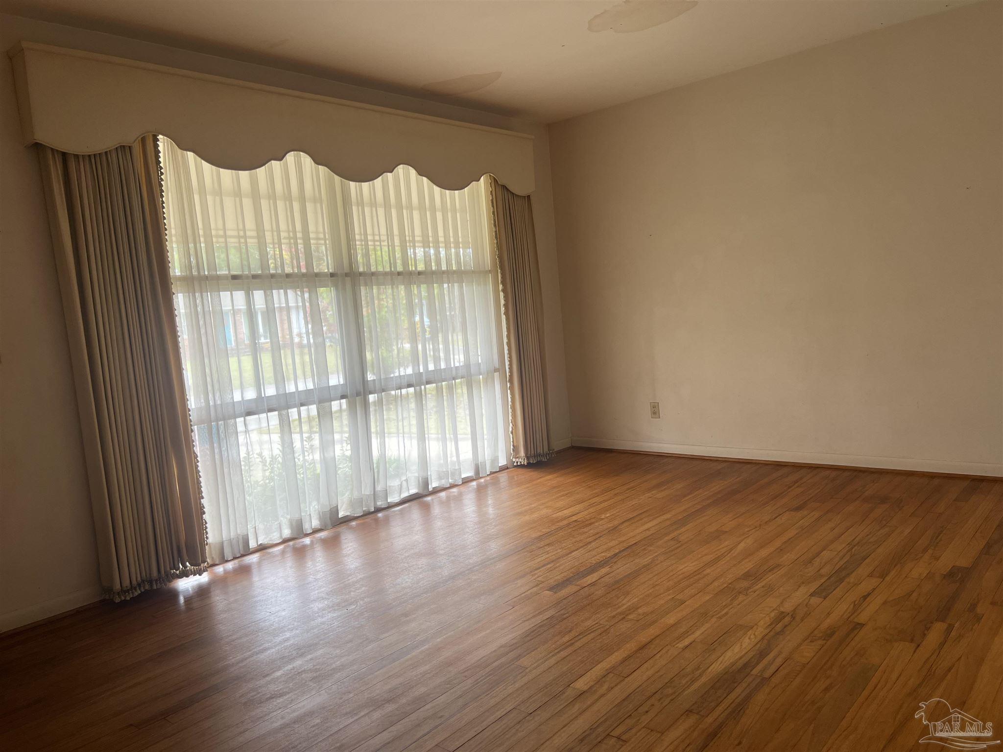 6020 Hilltop Road Pensacola, FL 32504 - Photo 2 of 27 a view of wooden floor in an empty room