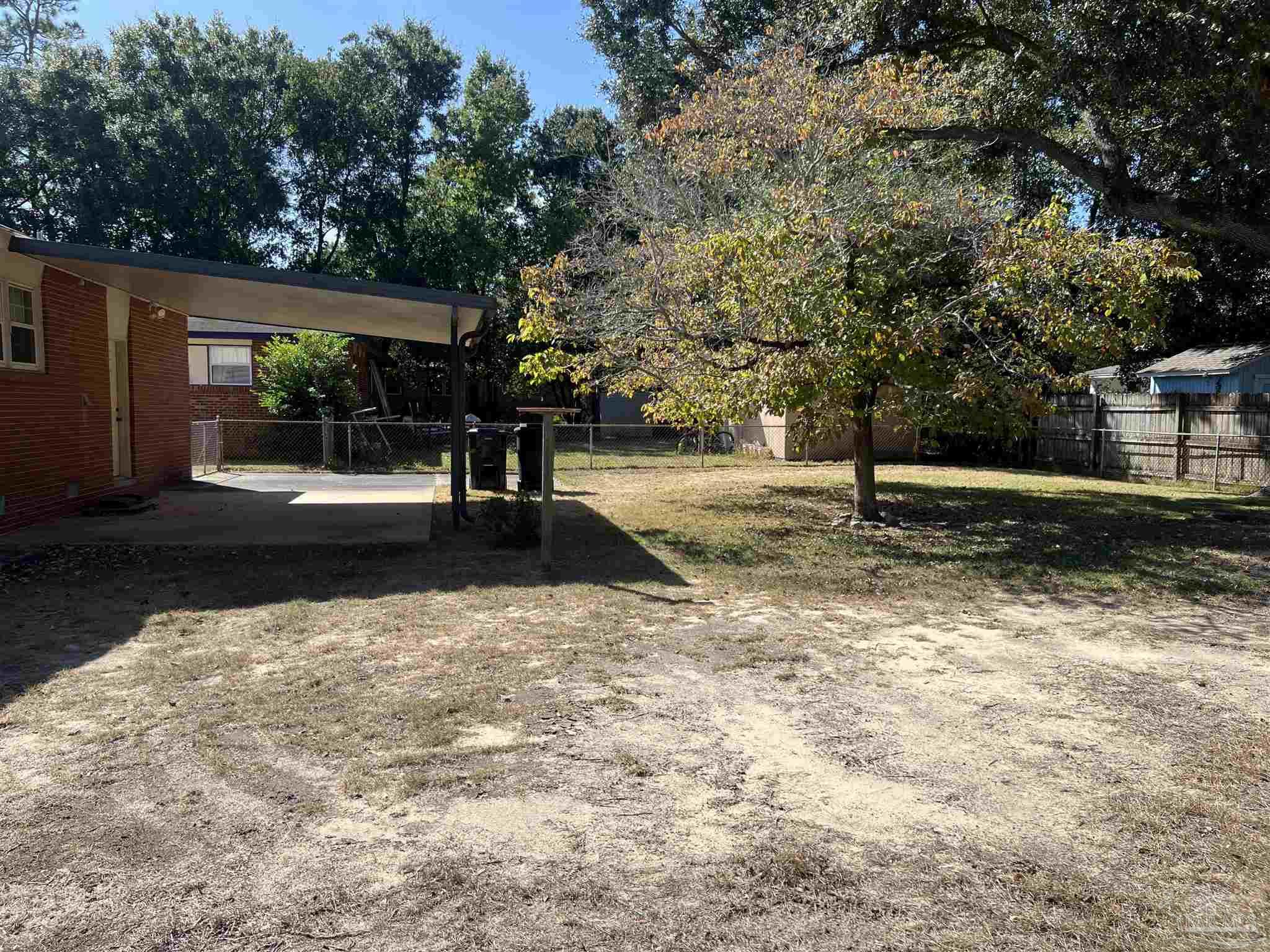 6020 Hilltop Road Pensacola, FL 32504 - Photo 23 of 27 a view of a yard with plants and trees