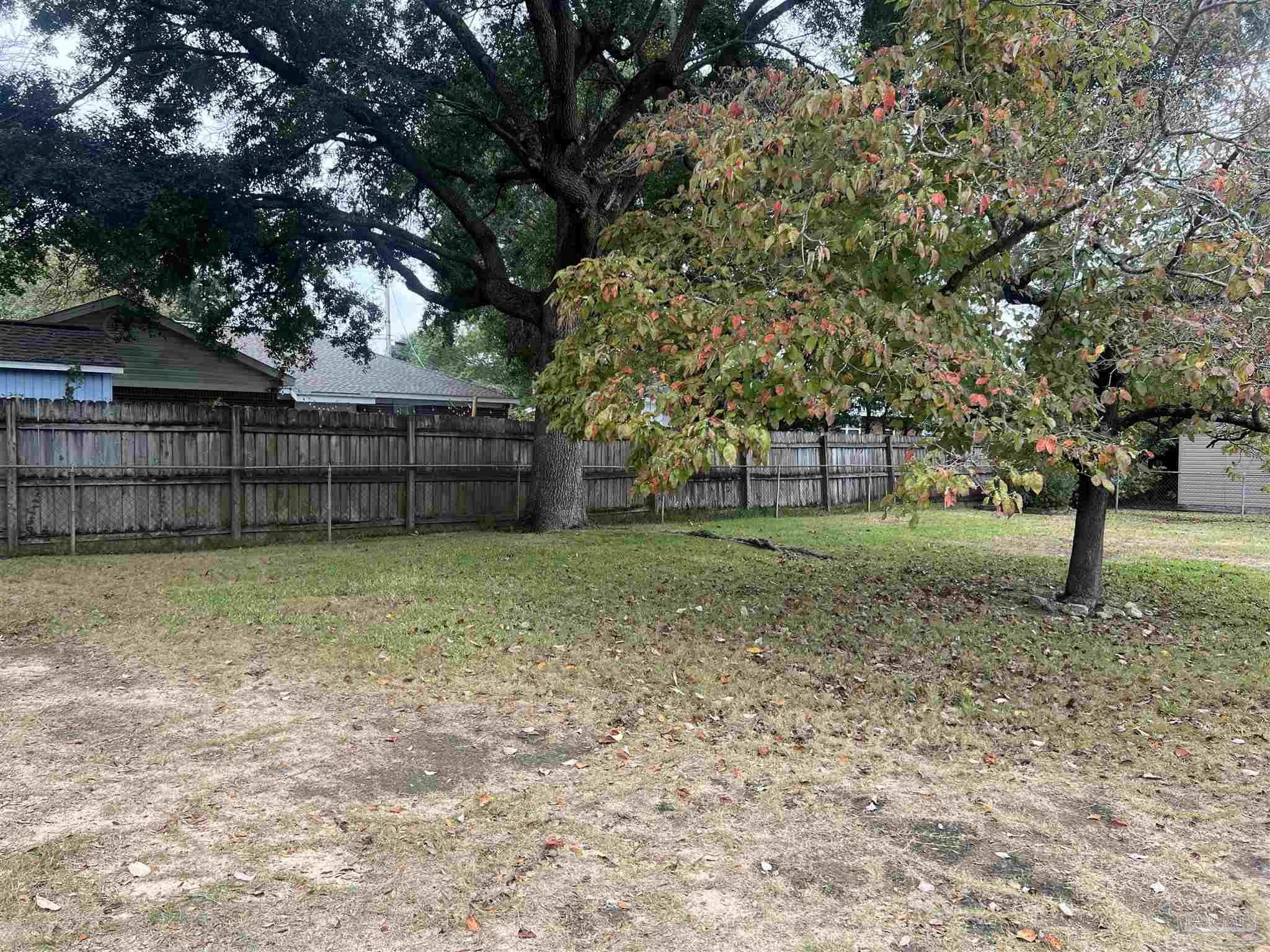 6020 Hilltop Road Pensacola, FL 32504 - Photo 24 of 27 a backyard of a house with lots of green space