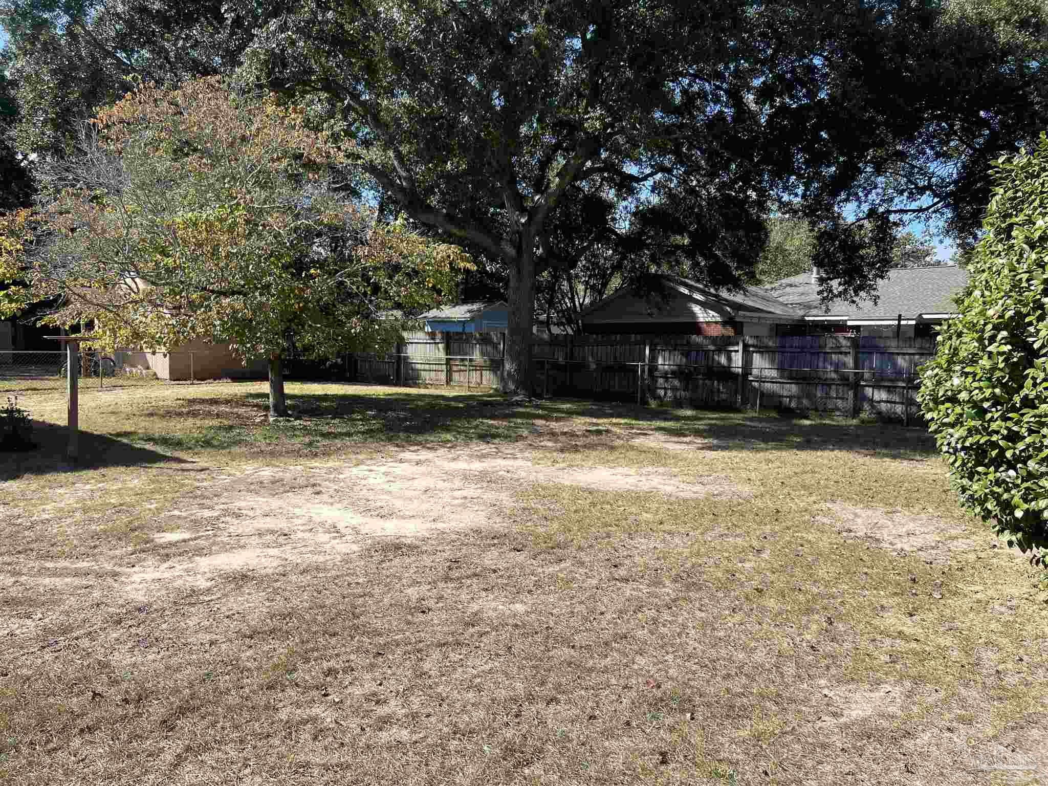 6020 Hilltop Road Pensacola, FL 32504 - Photo 26 of 27 a house with trees in front of it