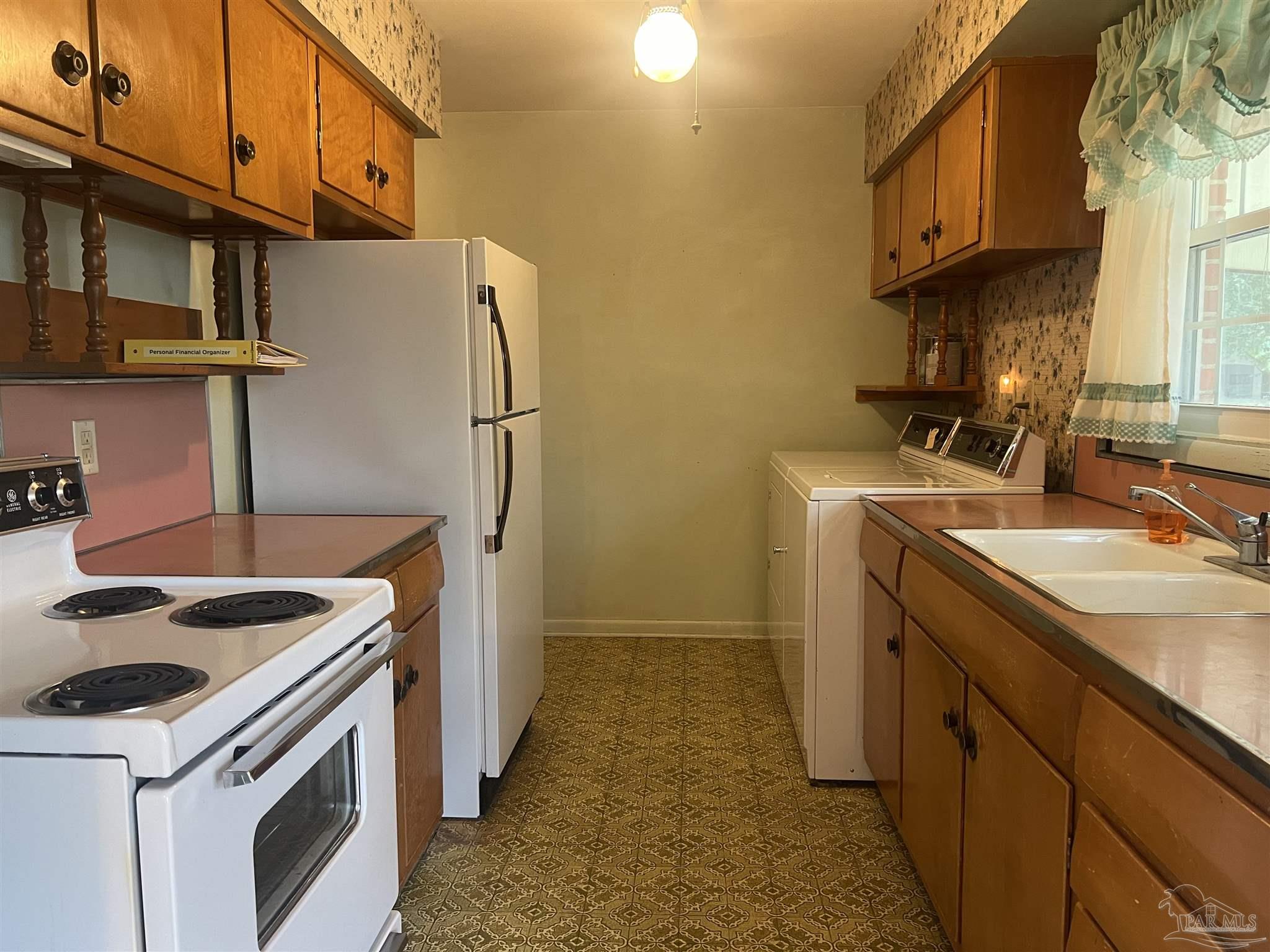 6020 Hilltop Road Pensacola, FL 32504 - Photo 5 of 27 a kitchen with a sink stove and refrigerator