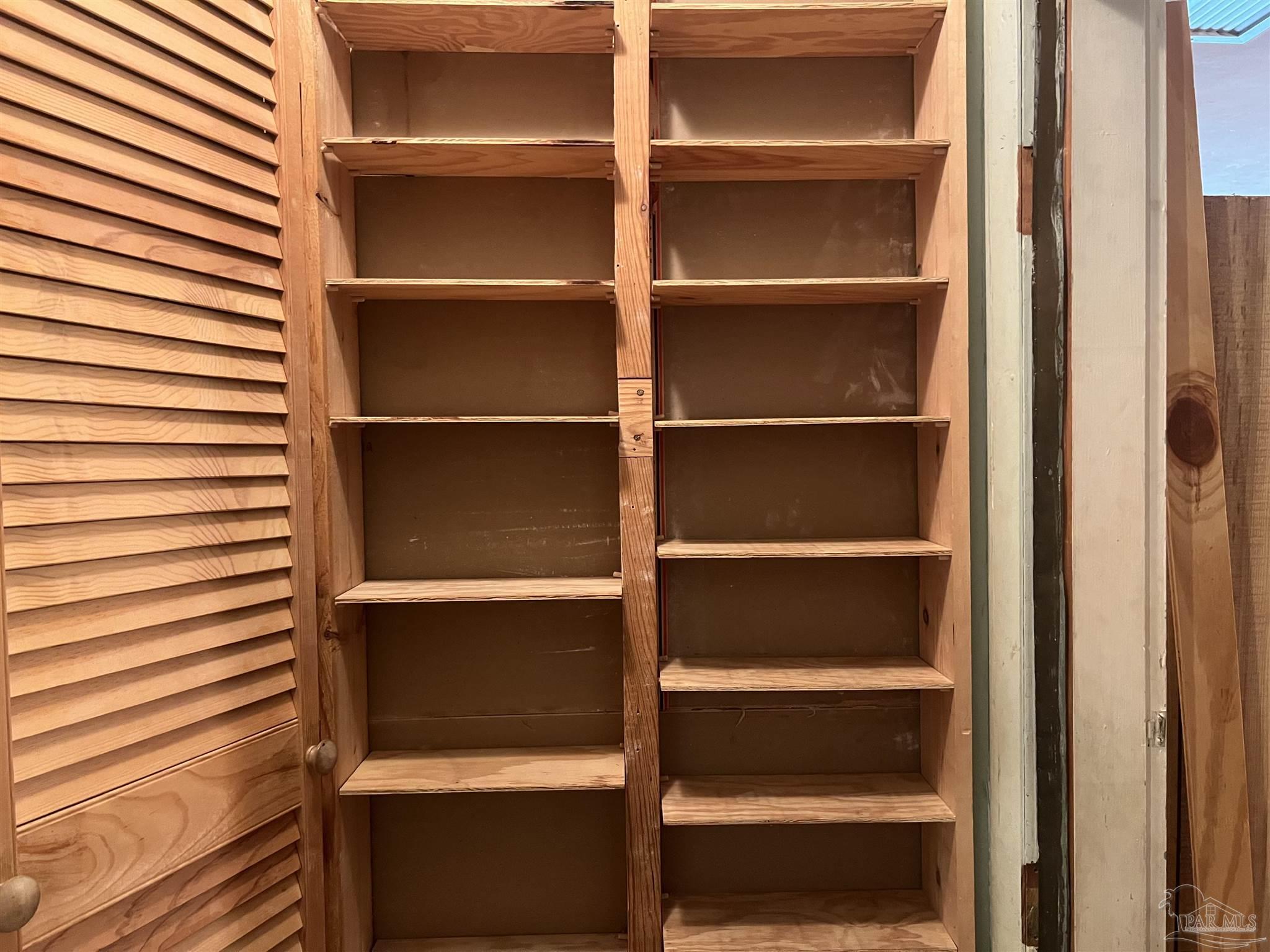6020 Hilltop Road Pensacola, FL 32504 - Photo 8 of 27 a view of walk in closet with empty racks