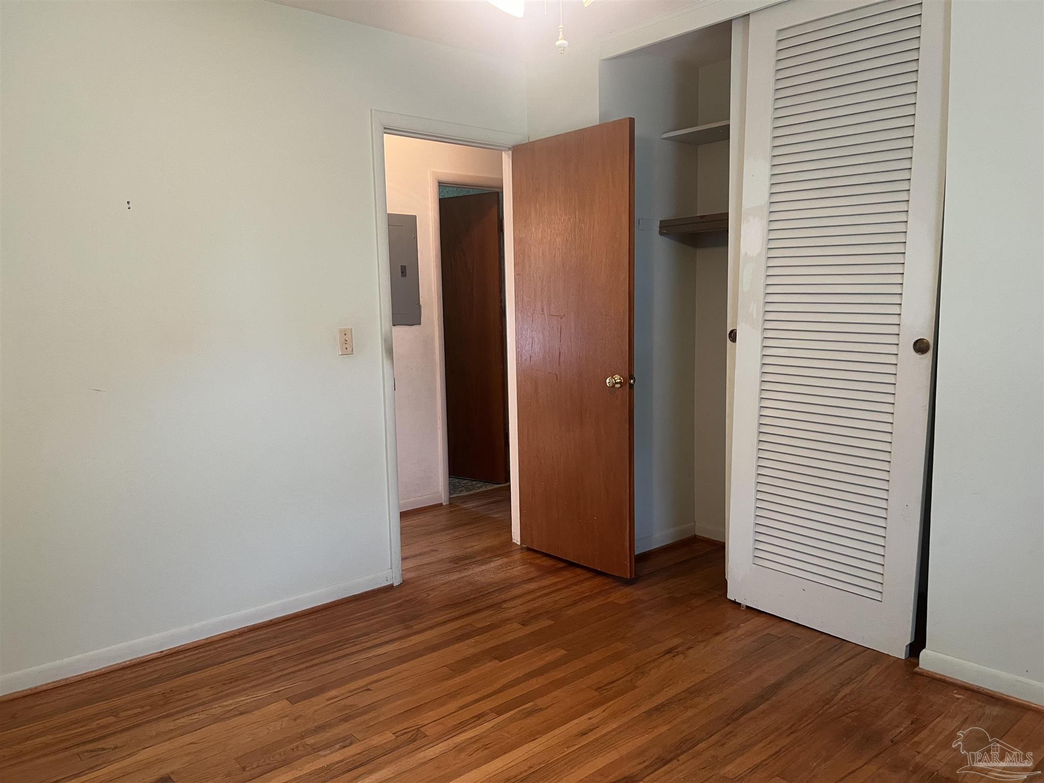 6020 Hilltop Road Pensacola, FL 32504 - Photo 9 of 27 an empty room with wooden floor and closet