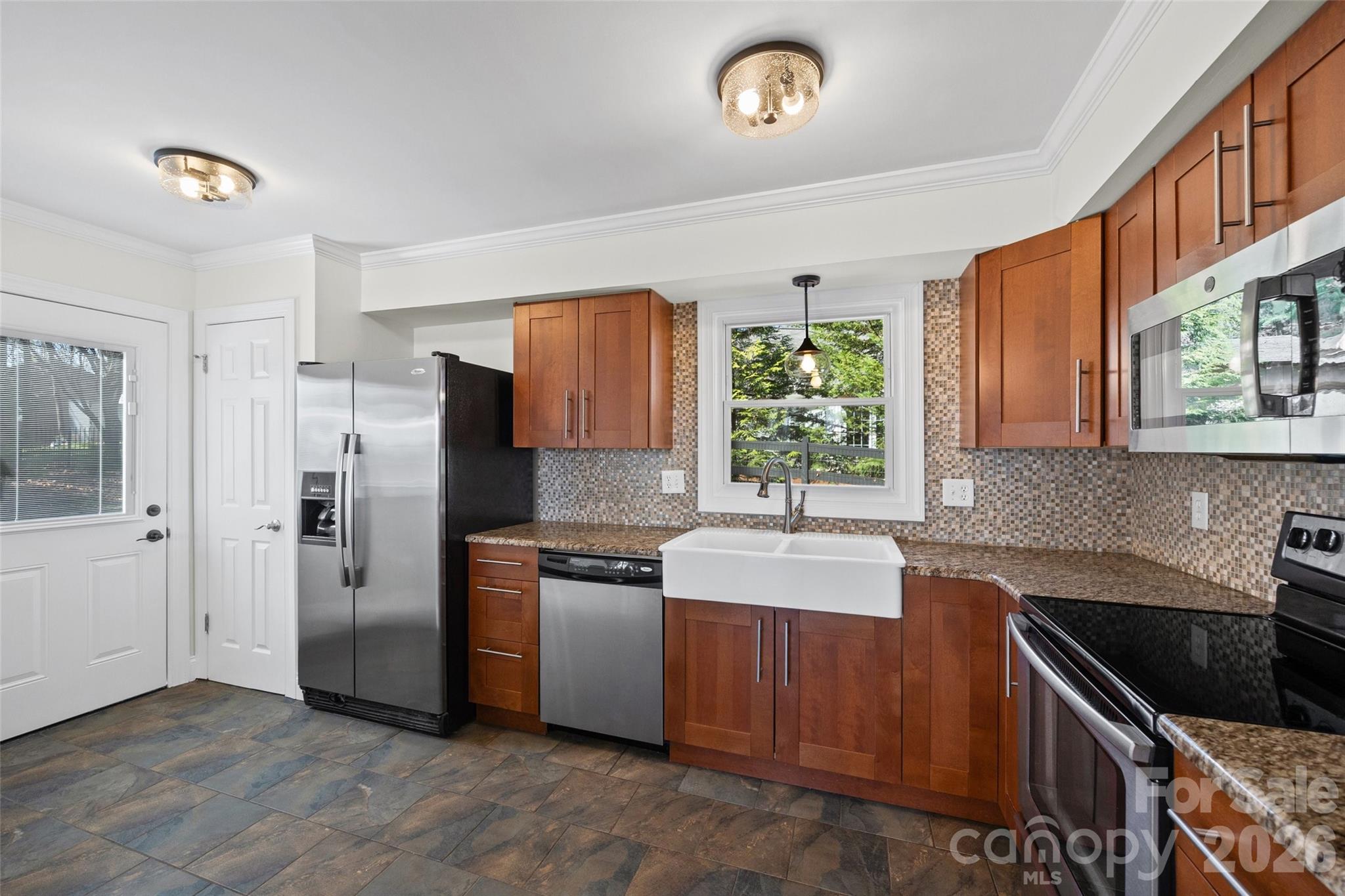 16149 Haroa Court Fort Mill, SC 29708 - Photo 13 of 43 a kitchen with stainless steel appliances granite countertop a sink stove and refrigerator
