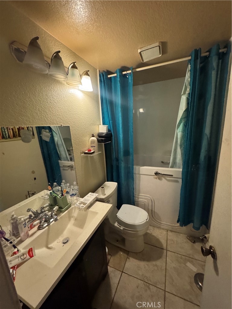 1266 Lorraine Place Rialto, CA 92376 - Photo 13 of 15 a bathroom with a sink and mirror