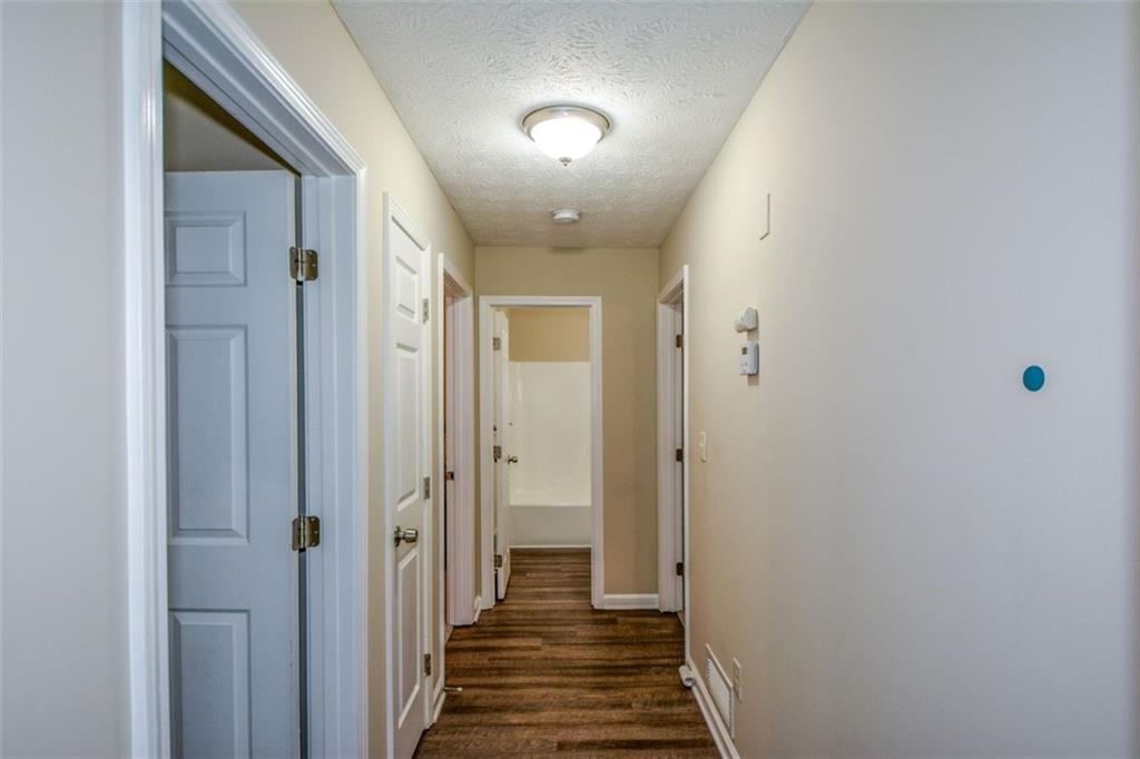 2895 Fairview Road Covington, GA 30016 - Photo 13 of 31 a view of a hallway with wooden floor and closet area