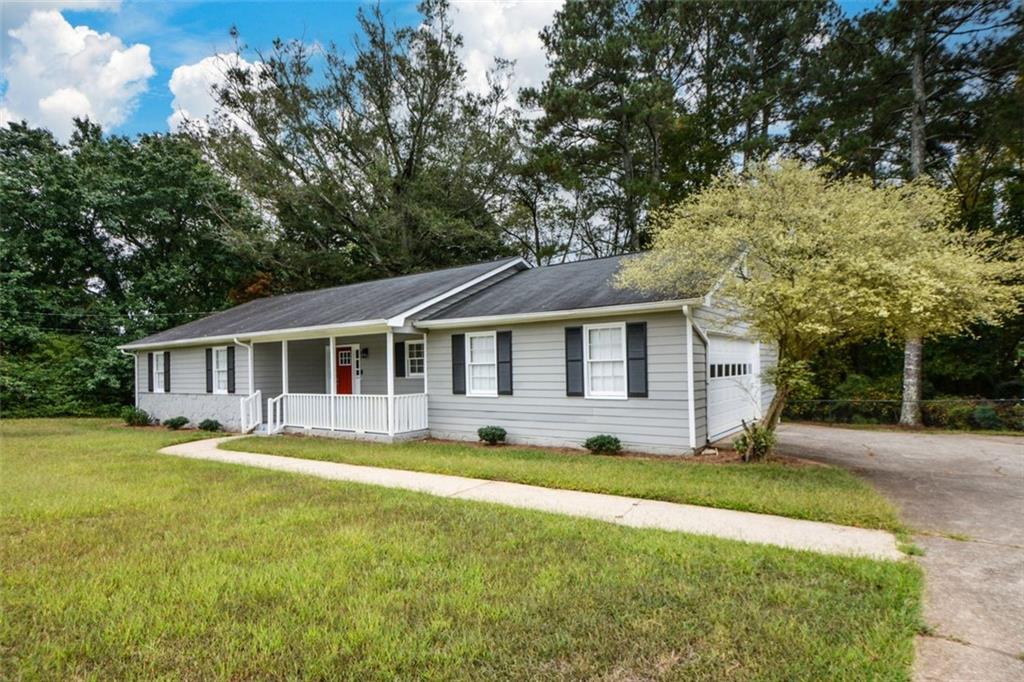 2895 Fairview Road Covington, GA 30016 - Photo 2 of 31 a front view of a house with yard and green space