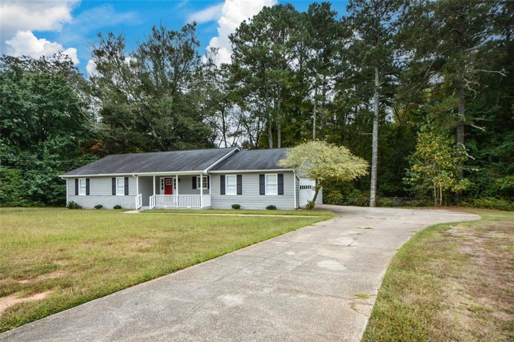 2895 Fairview Road Covington, GA 30016 - Photo 3 of 31 a front view of a house with a garden