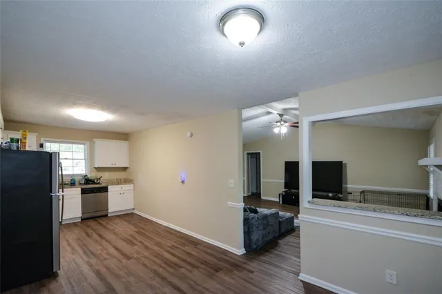a view of a kitchen with a sink stove refrigerator and a fireplace