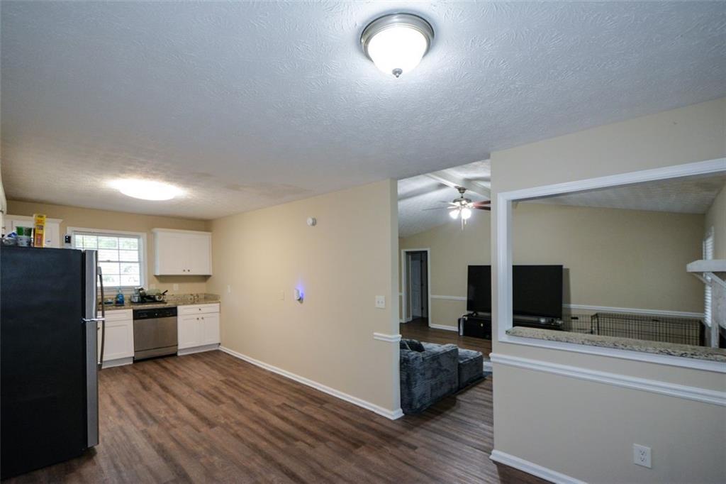 2895 Fairview Road Covington, GA 30016 - Photo 6 of 31 a view of a kitchen with a sink stove refrigerator and a fireplace